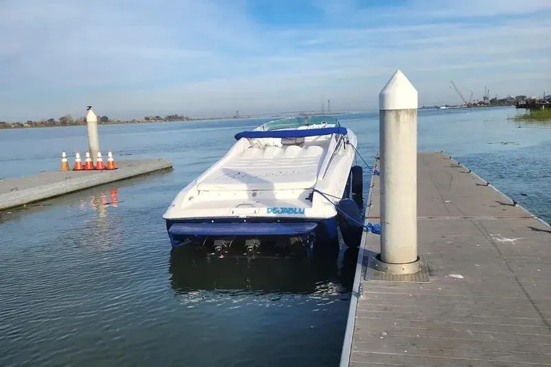  Yacht Photos Pics 2000 Donzi Daytona 45 boat docked at a marina on a sunny day.