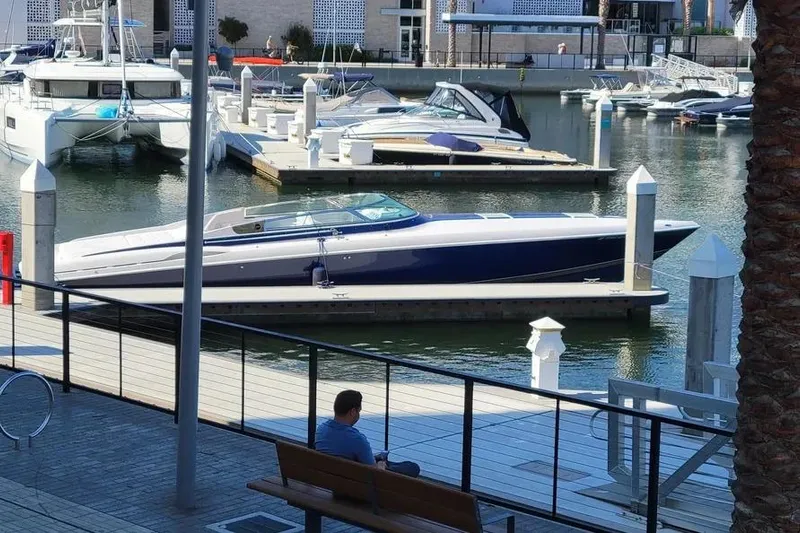  Yacht Photos Pics 2000 Donzi Daytona 45 boat docked in a marina with other vessels.