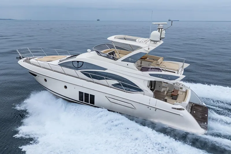  Yacht Photos Pics 2017 Azimut 54 Flybridge yacht cruising on open water, showcasing sleek design and luxury.
