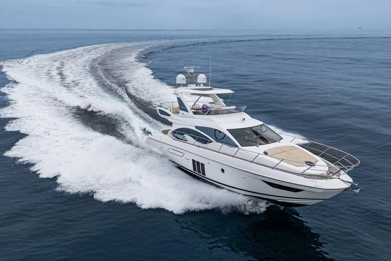  Yacht Photos Pics 2017 Azimut 54 Flybridge yacht cruising on open sea, leaving a wake trail.