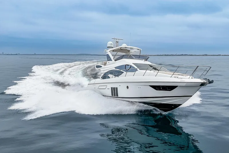 Yacht Photos Pics Azimut 54 Flybridge 2017 yacht cruising on open water, creating a dynamic wake.