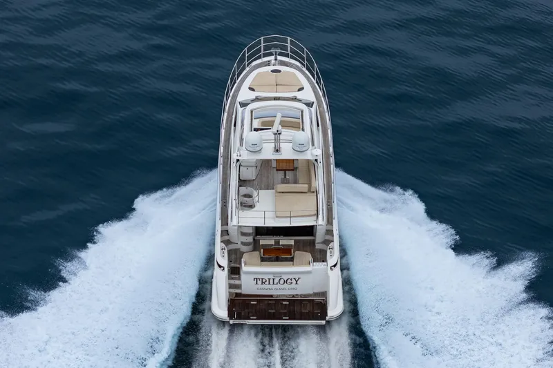  Yacht Photos Pics Azimut 54 Flybridge 2017 yacht cruising on open water, rear view.