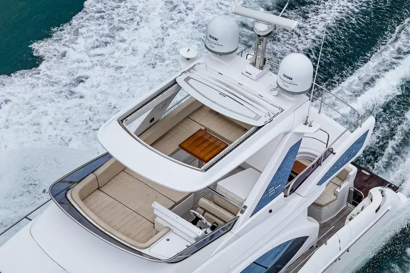  Yacht Photos Pics 2017 Azimut 54 Flybridge yacht cruising on open water, aerial view.
