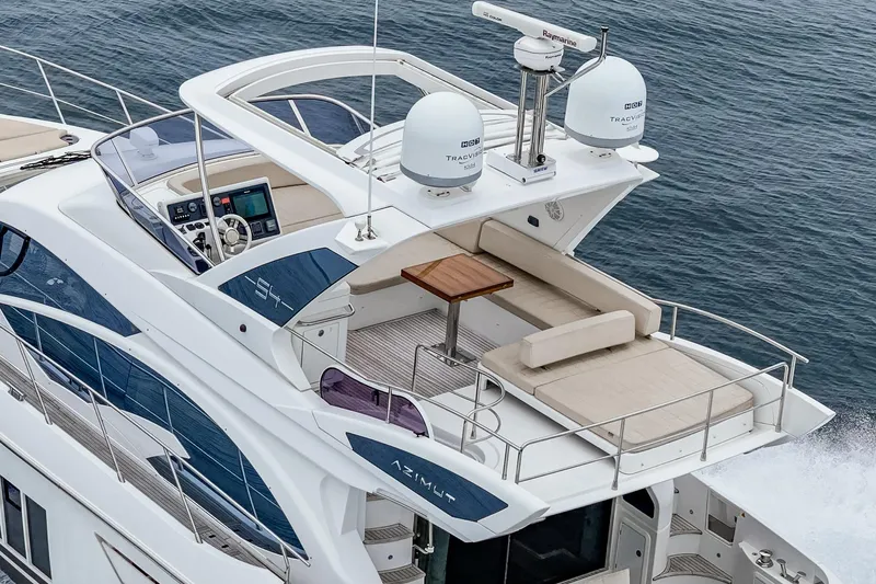  Yacht Photos Pics 2017 Azimut 54 Flybridge yacht cruising on the ocean, featuring a spacious deck and modern design.