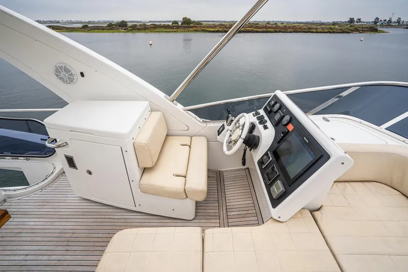  Yacht Photos Pics Flybridge of 2017 Azimut 54, featuring helm station and seating, overlooking serene waterway.