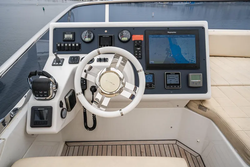  Yacht Photos Pics 2017 Azimut 54 Flybridge helm with navigation controls and steering wheel.