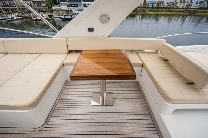 Yacht Photos Pics Luxurious seating area on 2017 Azimut 54 Flybridge yacht with wooden table.