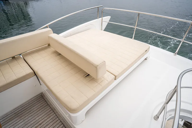  Yacht Photos Pics Luxurious seating area on 2017 Azimut 54 Flybridge yacht, overlooking calm waters.