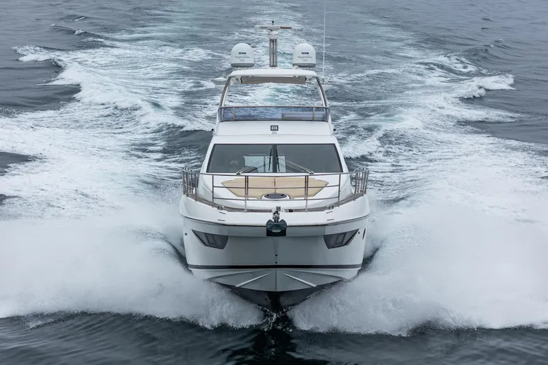  Yacht Photos Pics 2017 Azimut 54 Flybridge yacht cruising on open water, creating a dynamic wake.