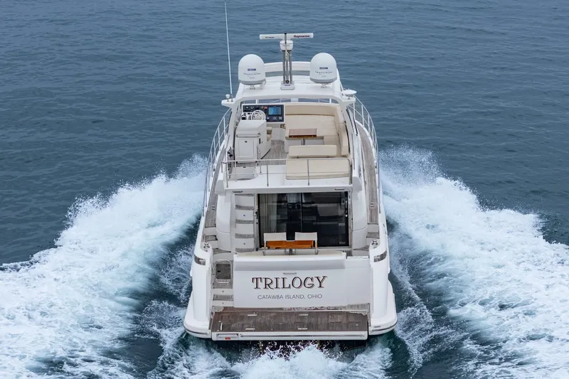  Yacht Photos Pics Azimut 54 Flybridge 2017 yacht cruising on open water, rear view.