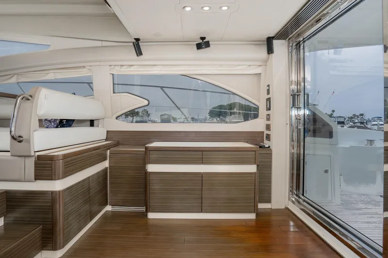  Yacht Photos Pics Luxurious interior of 2017 Azimut 54 Flybridge yacht with modern wood finishes and large windows.