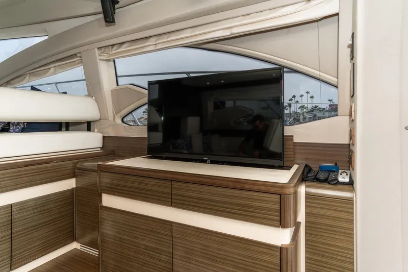 Yacht Photos Pics Luxurious interior of 2017 Azimut 54 Flybridge yacht with modern TV and wood finish.