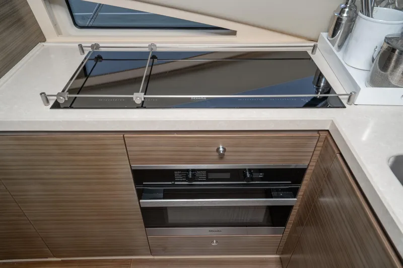  Yacht Photos Pics Modern kitchen area in a 2017 Azimut 54 Flybridge yacht with sleek appliances.