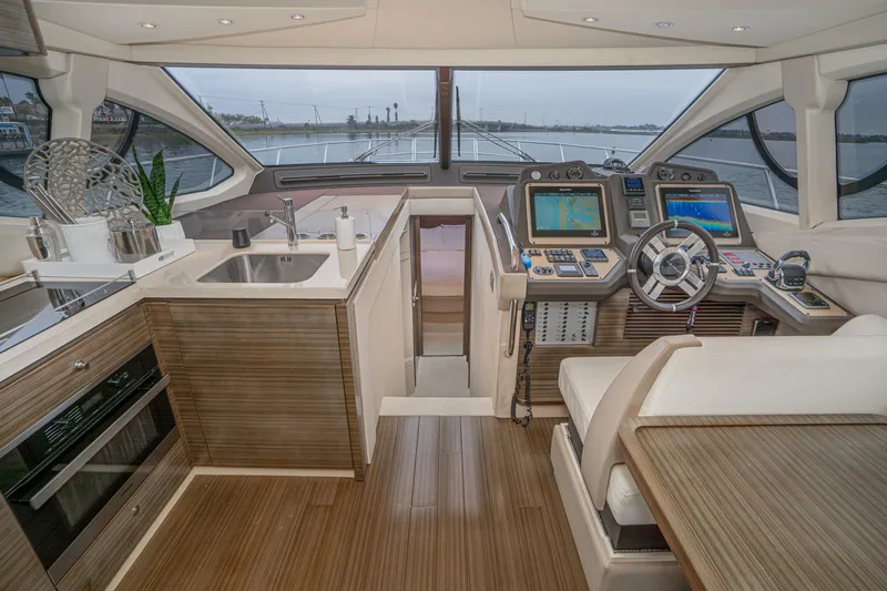  Yacht Photos Pics Luxurious 2017 Azimut 54 Flybridge yacht interior with modern helm and kitchen area.