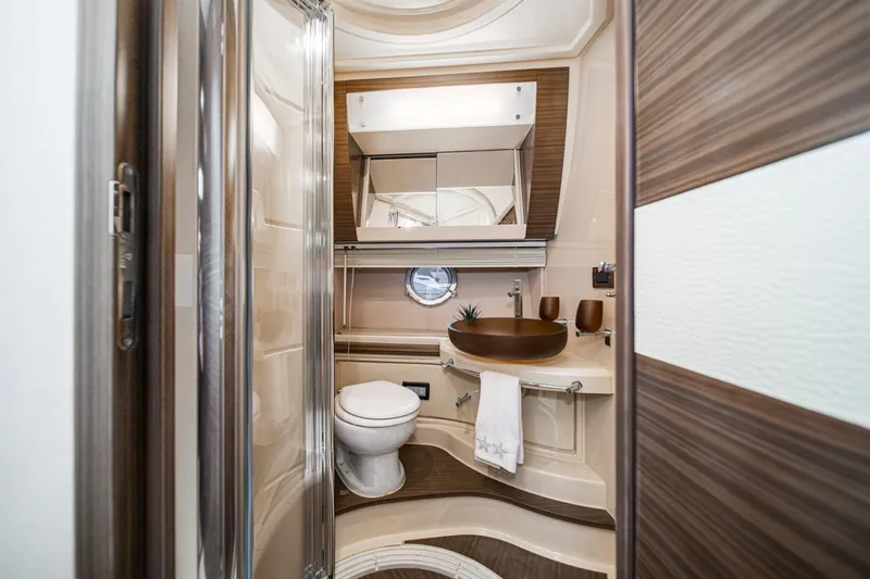  Yacht Photos Pics Luxurious bathroom interior of 2017 Azimut 54 Flybridge yacht, featuring modern fixtures and elegant design.