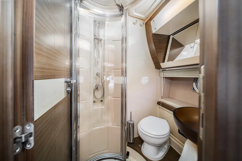  Yacht Photos Pics Luxurious bathroom in 2017 Azimut 54 Flybridge yacht with modern fixtures and elegant design.