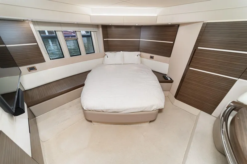  Yacht Photos Pics Luxurious bedroom interior of 2017 Azimut 54 Flybridge yacht with modern design elements.
