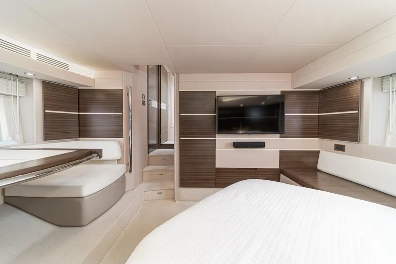  Yacht Photos Pics Luxurious interior of 2017 Azimut 54 Flybridge yacht with modern wood paneling and TV.