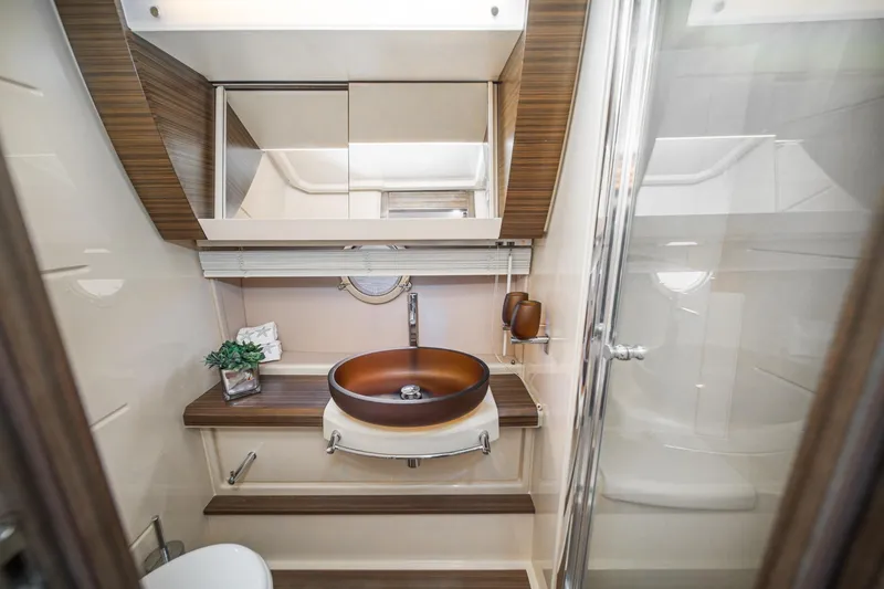  Yacht Photos Pics Luxurious bathroom interior of 2017 Azimut 54 Flybridge yacht with modern fixtures.