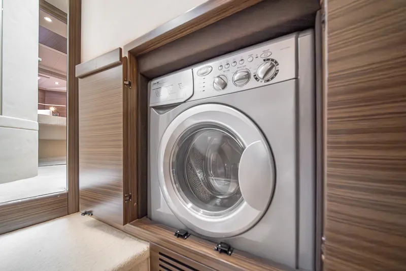  Yacht Photos Pics Built-in washing machine on 2017 Azimut 54 Flybridge yacht, wooden cabinetry.