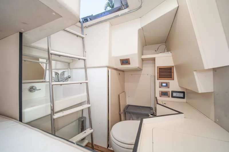  Yacht Photos Pics 2017 Azimut 54 Flybridge yacht interior with compact bathroom and ladder access.