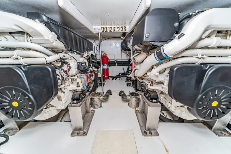  Yacht Photos Pics Engine room of 2017 Azimut 54 Flybridge yacht, featuring dual engines and fire extinguisher.
