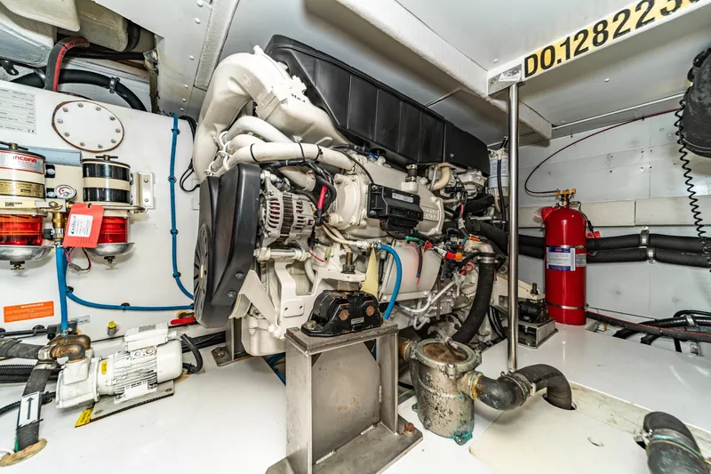  Yacht Photos Pics Engine room of 2017 Azimut 54 Flybridge yacht, featuring mechanical components and fire extinguisher.