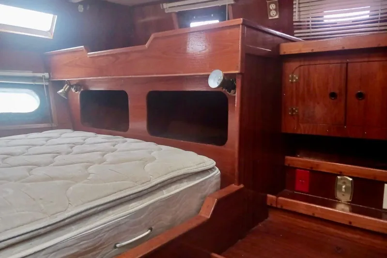 Cloud Chaser Yacht Photos Pics Interior cabin of 1997 Hike Metal Products ketch with wooden furnishings and mattress.