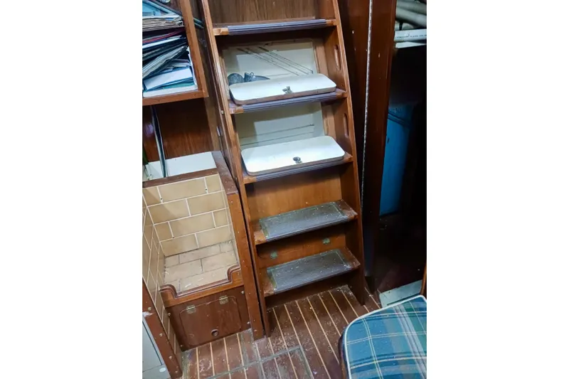 Cloud Chaser Yacht Photos Pics Interior of 1997 Hike Metal Products ketch, featuring wooden stairs and storage area.