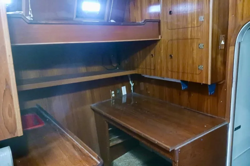 Cloud Chaser Yacht Photos Pics Interior of 1997 Hike Metal Products ketch, featuring wooden cabinetry and desk area.