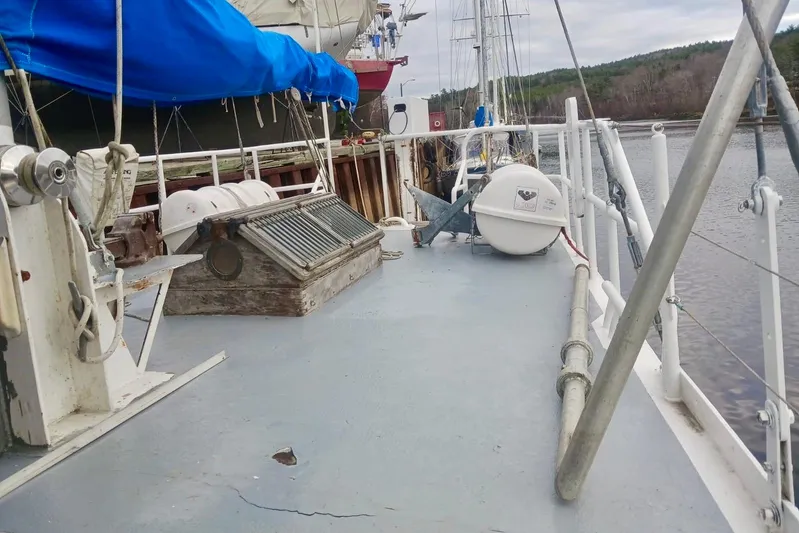 Cloud Chaser Yacht Photos Pics Deck view of a 1997 Hike Metal Products 67-foot steel full-keel ketch, docked by a river.