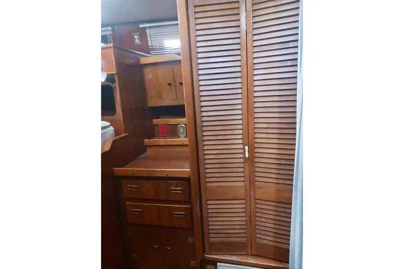 Cloud Chaser Yacht Photos Pics Interior of 1997 Hike Metal Products ketch with wooden cabinets and louvered doors.