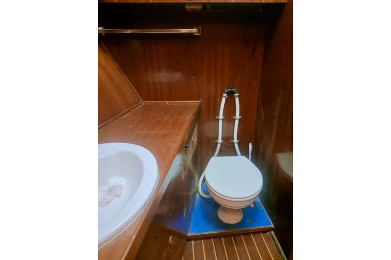 Cloud Chaser Yacht Photos Pics Interior of 1997 Hike Metal Products ketch bathroom with wooden finish and marine toilet.
