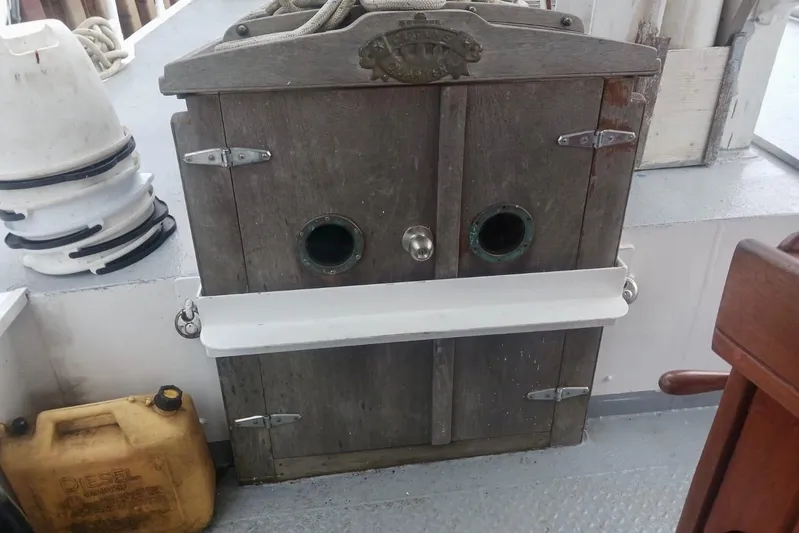 Cloud Chaser Yacht Photos Pics Wooden hatch on 1997 Hike Metal Products ketch, with nautical equipment and diesel container nearby.