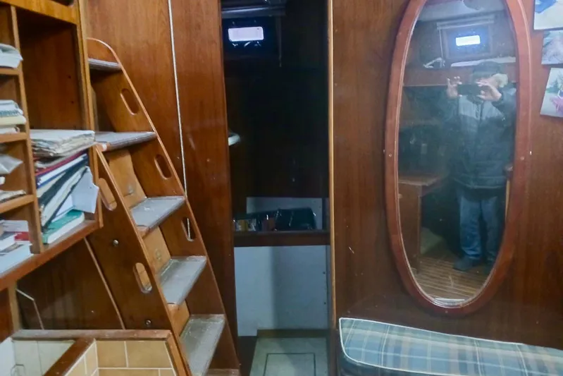 Cloud Chaser Yacht Photos Pics Interior of a 1997 Hike Metal Products 67-foot ketch, featuring wooden stairs and mirror.