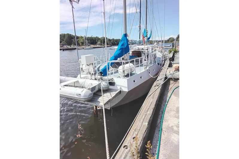 Cloud Chaser Yacht Photos Pics 67-foot steel ketch by Hike Metal Products, docked, with blue covers, 1997 model.