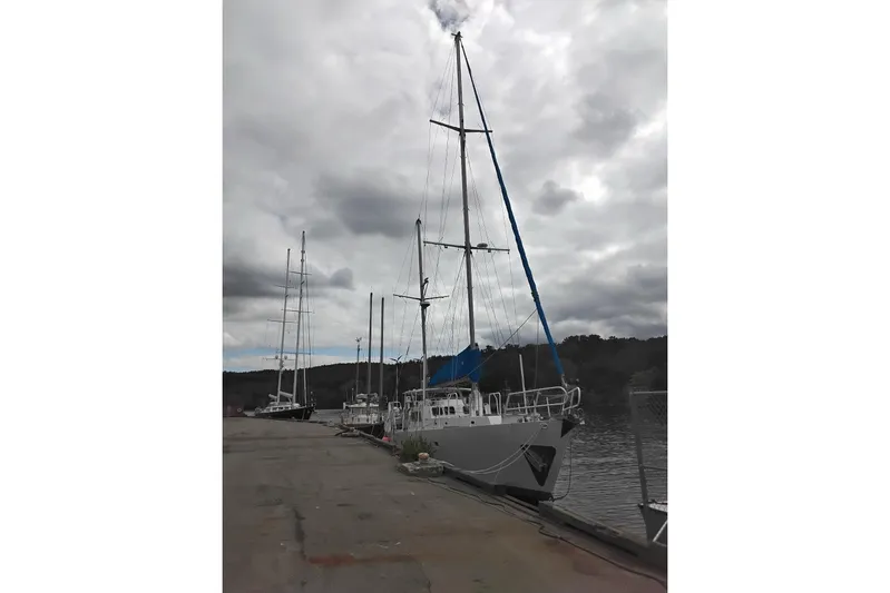 Cloud Chaser Yacht Photos Pics 67-foot steel ketch by Hike Metal Products, docked under cloudy skies, 1997 model.