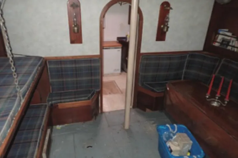 Cloud Chaser Yacht Photos Pics Interior of 1997 Hike Metal Products 67-foot ketch with plaid seating and wooden accents.