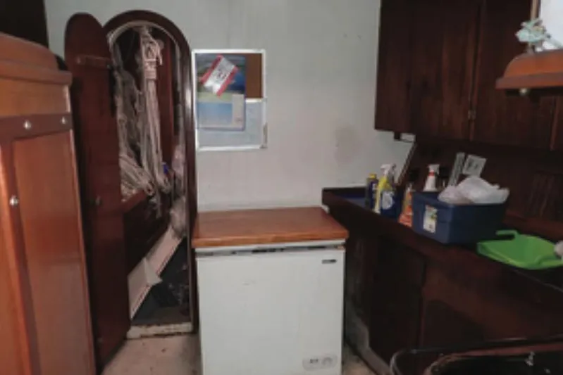 Cloud Chaser Yacht Photos Pics Interior of 1997 Hike Metal Products ketch, featuring wooden cabinetry and compact kitchen area.