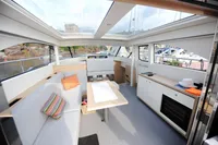 Luxurious interior of 2018 Steeler 52s yacht with modern seating and panoramic windows.