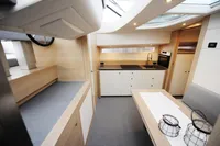 Luxurious interior of 2018 Steeler 52s yacht with modern kitchen and seating area.