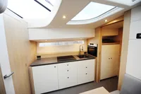 Modern kitchen interior of 2018 Steeler 52s yacht with sleek cabinetry and skylight.