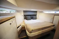 Luxurious cabin interior of 2018 Steeler 52s yacht with modern bedding.