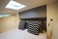 Interior cabin of 2018 Steeler 52s yacht with modern bedding and lighting.