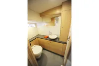 Modern bathroom interior in 2018 Steeler 52s yacht, featuring sleek wood cabinetry and vessel sink.