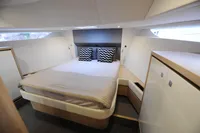 Luxurious cabin interior of 2018 Steeler 52s yacht with modern bedding and storage.