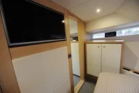 Interior of 2018 Steeler 52s yacht with modern cabinetry and wall-mounted TV.