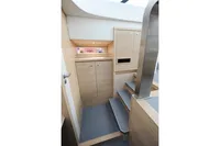 Interior of 2018 Steeler 52s yacht with modern wooden cabinetry and carpeted stairs.
