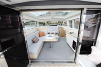 Luxurious interior of 2018 Steeler 52s yacht with modern seating and panoramic windows.