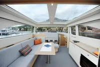 Luxurious interior of 2018 Steeler 52s yacht with panoramic windows and modern furnishings.